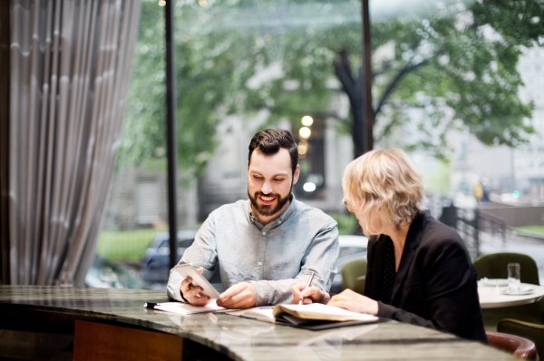 2 Richter team members discussing the budget