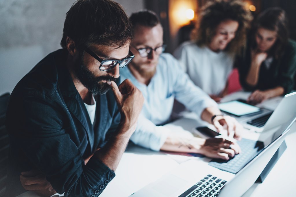 people looking at their investments on their computer screens